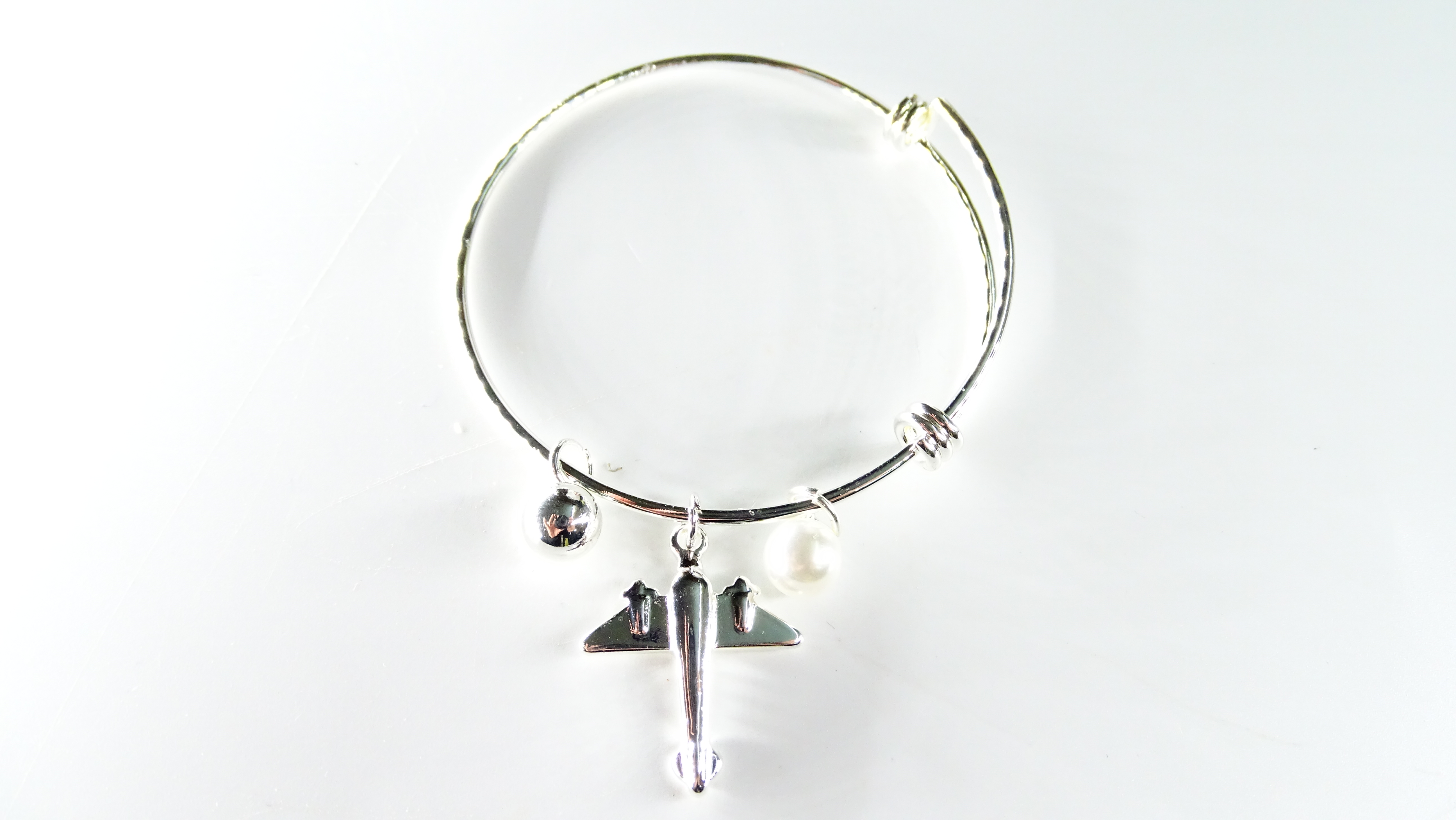 PULSERA ACERO BLANCO AVION CON PERLAS -